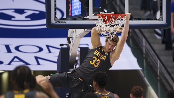 Feb 20, 2024; Provo, Utah, USA; Baylor Bears forward Caleb Lohner (33) hangs on the rim after a dunk
