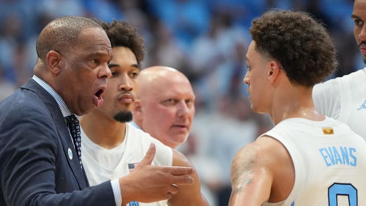 Nov 7, 2025; Chapel Hill, North Carolina, USA; North Carolina Tar Heels head coach Hubert Davis talks with guard Kyan Evans (0) in the second half at Dean E. Smith Center. Mandatory Credit: Bob Donnan-Imagn Images