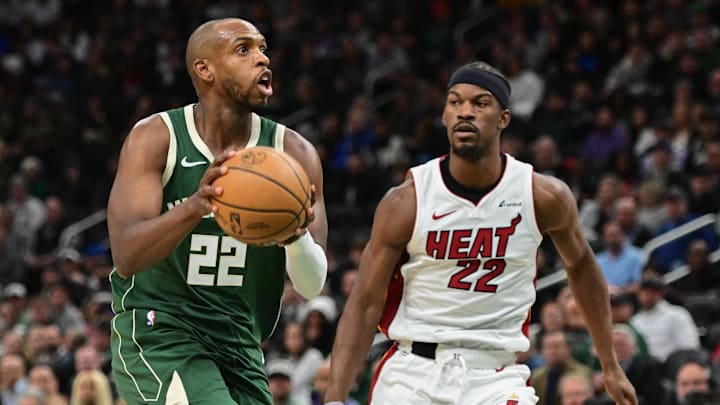 Oct 30, 2023; Milwaukee, Wisconsin, USA; Milwaukee Bucks center Khris Middleton (22) takes a shot against Miami Heat center Jimmy Butler (22) in the second quarter at Fiserv Forum. Mandatory Credit: Benny Sieu-Imagn Images