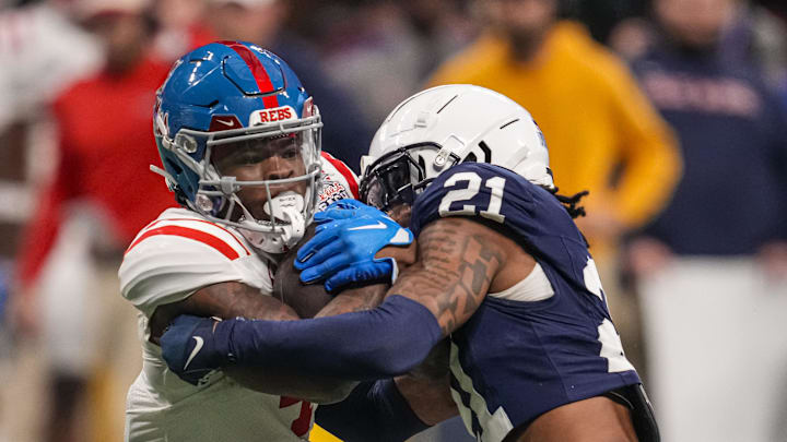 Dec 30, 2023; Atlanta, GA, USA; Mississippi Rebels running back Quinshon Judkins (4) is tackled by Penn State Nittany Lions safety Kevin Winston Jr. (21) during the second half at Mercedes-Benz Stadium. Mandatory Credit: Dale Zanine-Imagn Images Dec 30, 2023; Atlanta, GA, USA; Mississippi Rebels running back Quinshon Judkins (4) is tackled by Penn State Nittany Lions safety Kevin Winston Jr. (21) during the second half at Mercedes-Benz Stadium. Mandatory Credit: Dale Zanine-Imagn Images