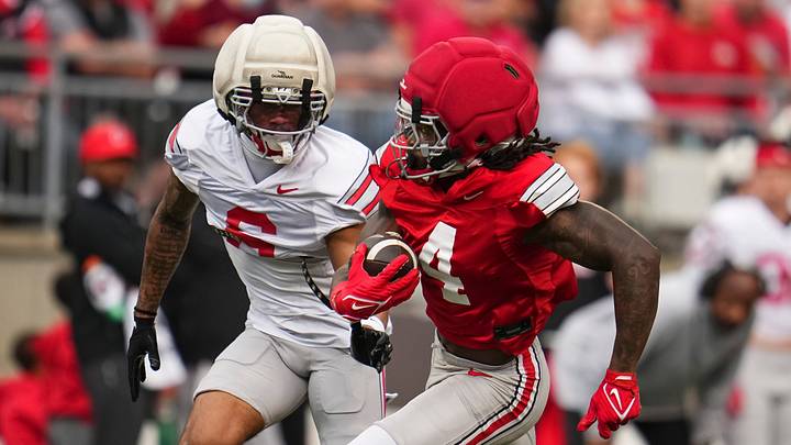 Wide receiver Jeremiah Smith (4) runs for a touchdown past cornerback Devin Sanchez (6) during the Ohio State football spring game at Ohio Stadium in Columbus on April 18, 2026. Wide receiver Jeremiah Smith (4) runs for a touchdown past cornerback Devin Sanchez (6) during the Ohio State football spring game at Ohio Stadium in Columbus on April 18, 2026.