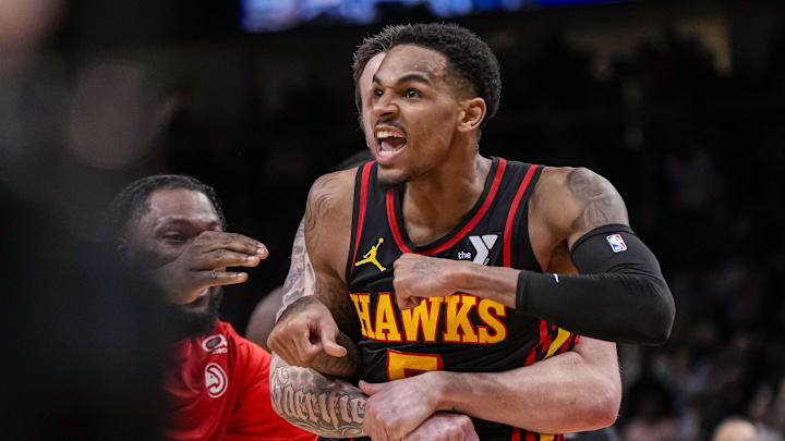 Mar 28, 2024; Atlanta, Georgia, USA; Atlanta Hawks guard Dejounte Murray (5) reacts after making a 3-pointer against the Boston Celtics. 