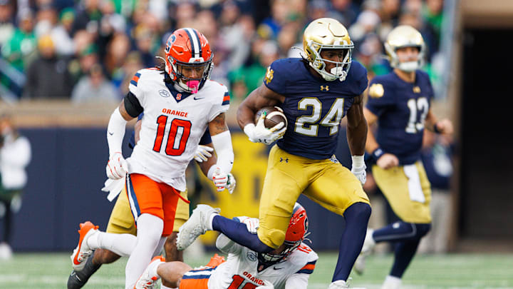 Notre Dame running back Jadarian Price (24), on his way to score a touchdown, avoids a tackle attempt by Syracuse defensive back Cornell Perry (19) in the first half of a NCAA football game at Notre Dame Stadium on Saturday, Nov. 22, 2025, in South Bend. Notre Dame running back Jadarian Price (24), on his way to score a touchdown, avoids a tackle attempt by Syracuse defensive back Cornell Perry (19) in the first half of a NCAA football game at Notre Dame Stadium on Saturday, Nov. 22, 2025, in South Bend.