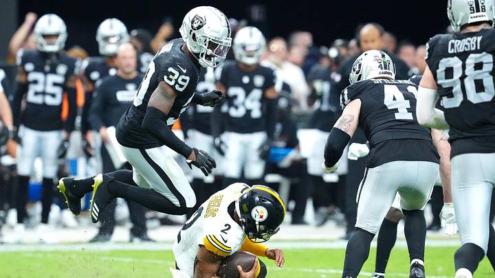 Oct 13, 2024; Paradise, Nevada, USA; Las Vegas Raiders cornerback Nate Hobbs (39) leaps over a sliding Pittsburgh Steelers quarterback Justin Fields (2) during the fourth quarter at Allegiant Stadium. Mandatory Credit: Stephen R. Sylvanie-Imagn Images