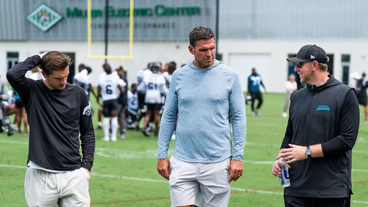 Jacksonville Jaguars general manager James Gladstone, left, Jacksonville Jaguars is executive vice president of football operations Tony Boselli, center and Jacksonville Jaguars head coach Liam Coen, right, all talk on the field after the Jacksonville Jaguars’ mandatory minicamp Tuesday June 10, 2025 at the Miller Electric Center in Jacksonville, Fla. [Doug Engle/Florida Times-Union]