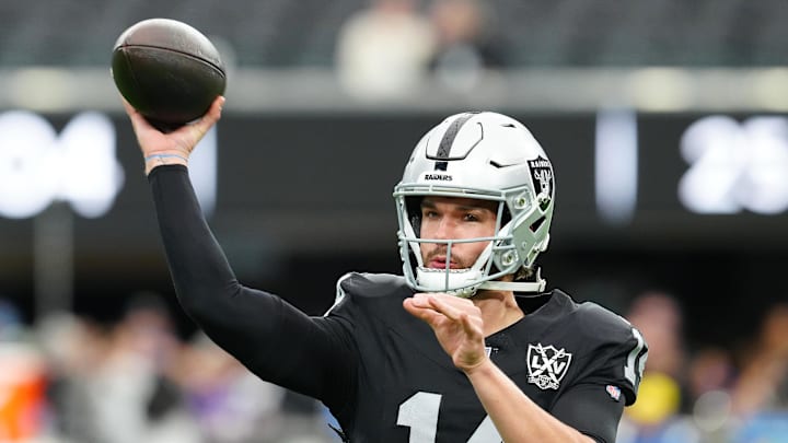 Jan 5, 2025; Paradise, Nevada, USA; Las Vegas Raiders quarterback Carter Bradley (14) warms up before a game against the Los Angeles Chargers at Allegiant Stadium. Mandatory Credit: Stephen R. Sylvanie-Imagn Images