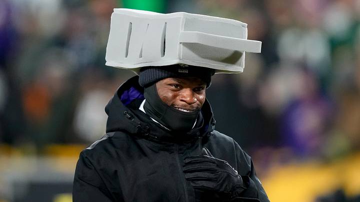 Dec 27, 2025; Green Bay, Wisconsin, USA; Baltimore Ravens quarterback Lamar Jackson (8) wears a cheese grater hat after the game against the Green Bay Packers at Lambeau Field. Mandatory Credit: Kayla Wolf-Imagn Images
