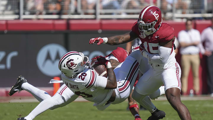 Oct 12, 2024; Tuscaloosa, Alabama, USA;  Alabama Crimson Tide defensive back Malachi Moore (13) and Alabama Crimson Tide linebacker Justin Jefferson (15) combine to tackle South Carolina Gamecocks tight end Michael Smith (20) at Bryant-Denny Stadium. Mandatory Credit: Gary Cosby Jr.-Imagn Images