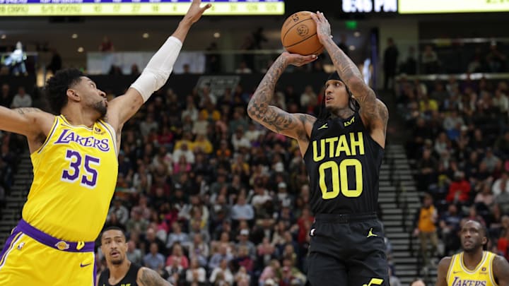 Feb 14, 2024; Salt Lake City, Utah, USA;  Utah Jazz guard Jordan Clarkson (00) shoots the ball past the arm of Los Angeles Lakers forward Christian Wood (35) during the second half at Delta Center. Mandatory Credit: Chris Nicoll-Imagn Images