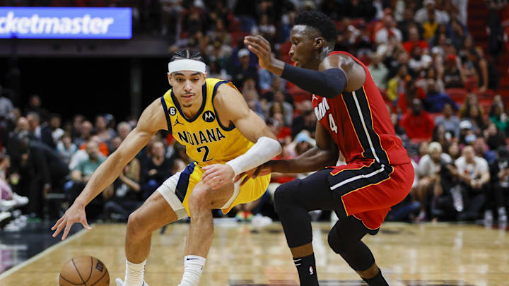Dec 23, 2022; Miami, Florida, USA; Indiana Pacers guard Andrew Nembhard (2) dribbles the basketball as Miami Heat guard Victor Oladipo (4) defends during the fourth quarter at FTX Arena. Mandatory Credit: Sam Navarro-Imagn Images