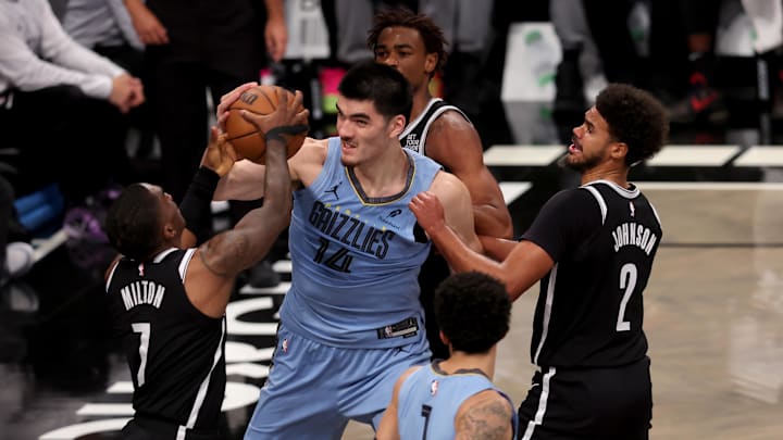 Nov 4, 2024; Brooklyn, New York, USA; Memphis Grizzlies center Zach Edey (14) fights for a rebound against Brooklyn Nets guard Shake Milton (7) and center Nic Claxton (33) and forward Cameron Johnson (2) during the second quarter at Barclays Center. Mandatory Credit: Brad Penner-Imagn Images
