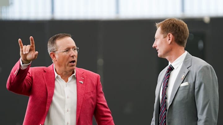 University of Cincinnati head football coach Scott Satterfield, left, and athletic director John Cunningham, right, have a conversation, Wednesday, June 11, 2025, at Sheakley Indoor Performance Center in Cincinnati.