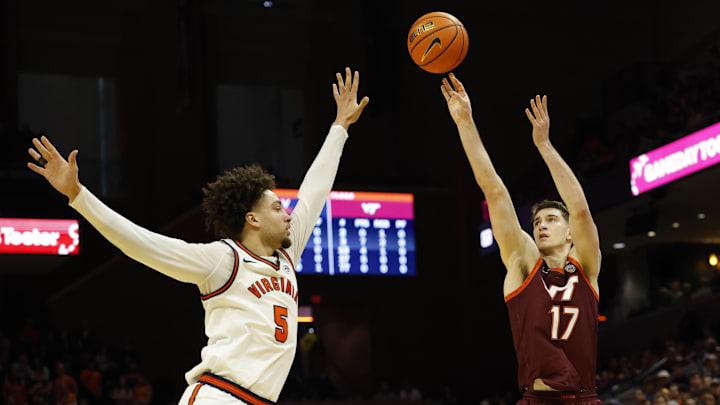 Mar 7, 2026; Charlottesville, Va.; Virginia Tech guard Neoklis Avdalas (17) shoots the ball over Virginia guard Sam Lewis (5).