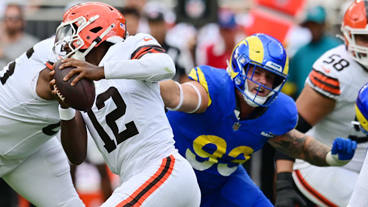 Aug 23, 2025; Cleveland, Ohio, USA; Los Angeles Rams defensive tackle Jack Heflin (93) grabs the jersey of Cleveland Browns quarterback Shedeur Sanders (12) during the second half at Huntington Bank Field. Mandatory Credit: Ken Blaze-Imagn Images