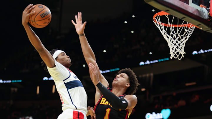 Nov 15, 2024; Atlanta, Georgia, USA; Washington Wizards guard Bilal Coulibaly (0) attempts to shoot against Atlanta Hawks forward Jalen Johnson (1) during the first quarter at State Farm Arena. Mandatory Credit: Jordan Godfree-Imagn Images
