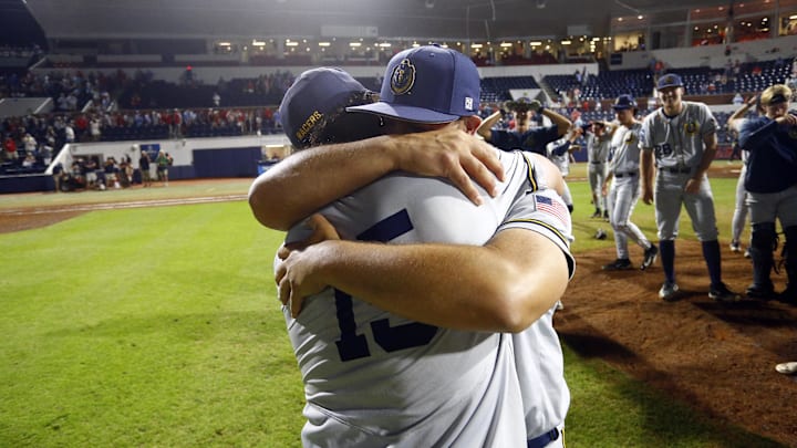 Jun 2, 2025; Oxford, MS, USA; Murray State Racers head coach Dan Skirka embraces outfielder Jonathan Hogart (15) after defeating the Mississippi Rebels in the Oxford Regional. Mandatory Credit: Petre Thomas-Imagn Images Jun 2, 2025; Oxford, MS, USA; Murray State Racers head coach Dan Skirka embraces outfielder Jonathan Hogart (15) after defeating the Mississippi Rebels in the Oxford Regional. Mandatory Credit: Petre Thomas-Imagn Images