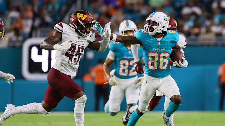 Miami Dolphins wide receiver Braylon Sanders stiff-arms Washington Commanders safety Dominique Hampton
