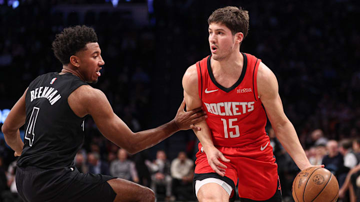 Feb 4, 2025; Brooklyn, New York, USA; Houston Rockets guard Reed Sheppard (15) dribbles as Brooklyn Nets guard Reece Beekman (4) defends during the first half at Barclays Center. Mandatory Credit: Vincent Carchietta-Imagn Images