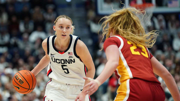 Dec 21, 2024; Hartford, Connecticut, USA; UConn Huskies guard Paige Bueckers (5) moves the ball against USC Trojans guard Avery Howell (23) in the first half at XL Center. Mandatory Credit: David Butler II-Imagn Images
