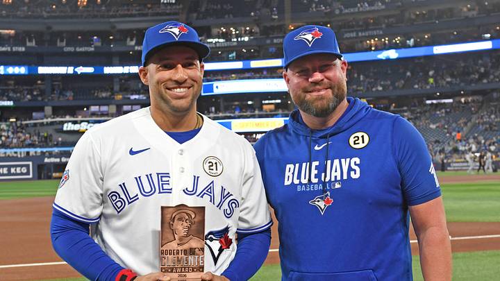 Sep 15, 2026; Toronto, Ontario, CAN;  Toronto Blue Jays designated hitter George Springer (4) receives the team Roberto Clemente award from manager John Schneider (14) before play against the Detroit Tigers at Rogers Centre.  Mandatory Credit: Dan Hamilton-Imagn Images