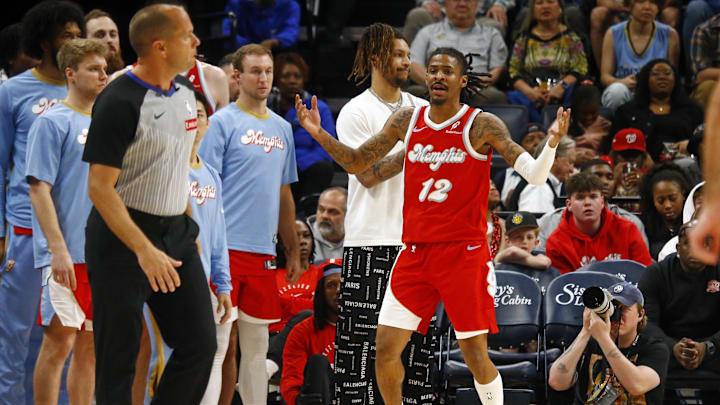 Apr 10, 2025; Memphis, Tennessee, USA; Memphis Grizzlies guard Ja Morant (12) reacts from the bench area during the fourth quarter against the Minnesota Timberwolves at FedExForum. Mandatory Credit: Petre Thomas-Imagn Images
