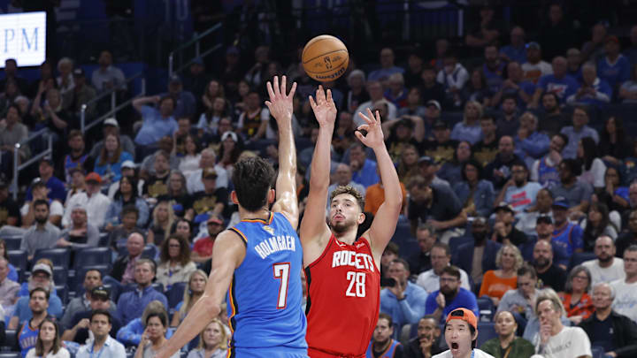Oct 21, 2025; Oklahoma City, Oklahoma, USA; Houston Rockets center Alperen Sengun (28) shoots over Oklahoma City Thunder center Chet Holmgren (7) during the second half at Paycom Center. Mandatory Credit: Alonzo Adams-Imagn Images
