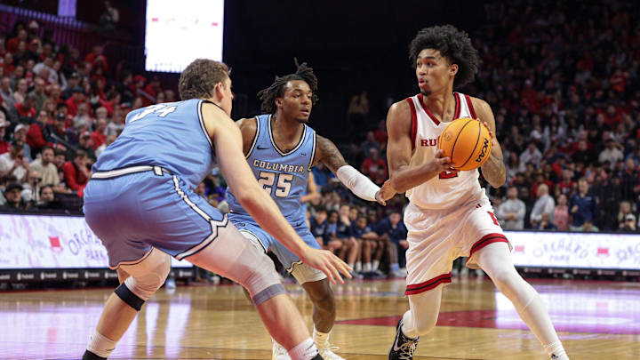 Dec 30, 2024; Piscataway, New Jersey, USA; Rutgers Scarlet Knights guard Dylan Harper (2) looks to pass as Columbia Lions guard Avery Brown (25) and forward Jake Tavroff (34) defend during the second half at Jersey Mike's Arena. Mandatory Credit: Vincent Carchietta-Imagn Images