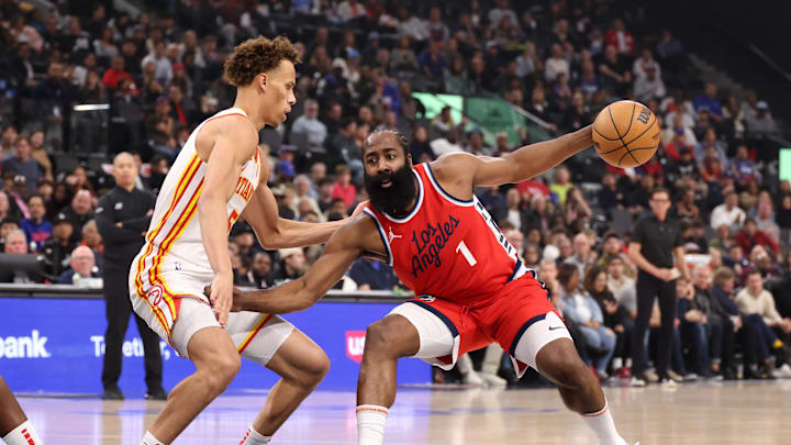 Jan 4, 2025; Inglewood, California, USA;  Los Angeles Clippers guard James Harden (1) dribbles the ball against Atlanta Hawks guard Dyson Daniels (5) during the first half at Intuit Dome. Mandatory Credit: Kiyoshi Mio-Imagn Images