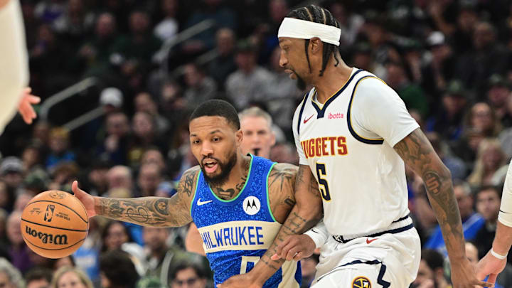 Feb 12, 2024; Milwaukee, Wisconsin, USA; Milwaukee Bucks guard Damian Lillard (0) is guarded by Denver Nuggets guard Kentavious Caldwell-Pope (5) in the first quarter at Fiserv Forum. Mandatory Credit: Benny Sieu-Imagn Images Feb 12, 2024; Milwaukee, Wisconsin, USA; Milwaukee Bucks guard Damian Lillard (0) is guarded by Denver Nuggets guard Kentavious Caldwell-Pope (5) in the first quarter at Fiserv Forum. Mandatory Credit: Benny Sieu-Imagn Images