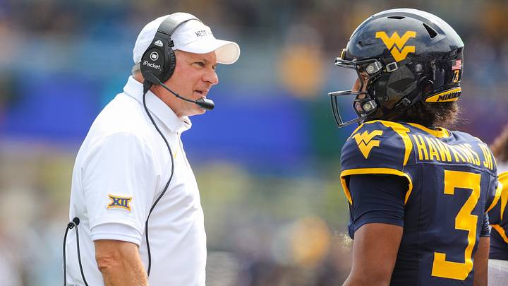 Sep 12, 2026; Morgantown, West Virginia, USA; West Virginia Mountaineers head coach Rich Rodriguez talks with West Virginia Mountaineers quarterback Michael Hawkins Jr. (3) during the first quarter against the UT Martin Skyhawks at Milan Puskar Stadium. Mandatory Credit: Ben Queen-Imagn Images Sep 12, 2026; Morgantown, West Virginia, USA; West Virginia Mountaineers head coach Rich Rodriguez talks with West Virginia Mountaineers quarterback Michael Hawkins Jr. (3) during the first quarter against the UT Martin Skyhawks at Milan Puskar Stadium. Mandatory Credit: Ben Queen-Imagn Images