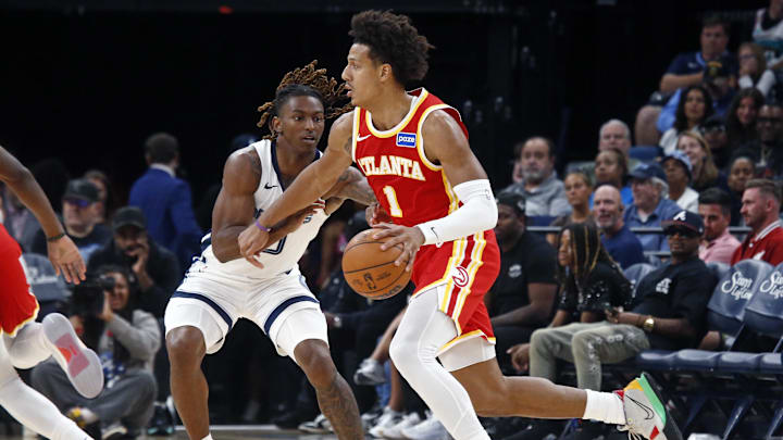 Oct 11, 2025; Memphis, Tennessee, USA;  Atlanta Hawks forward Jalen Johnson (1) dribbles as Memphis Grizzlies guard Javon Small (10) defends during the third quarter at FedExForum. Mandatory Credit: Petre Thomas-Imagn Images