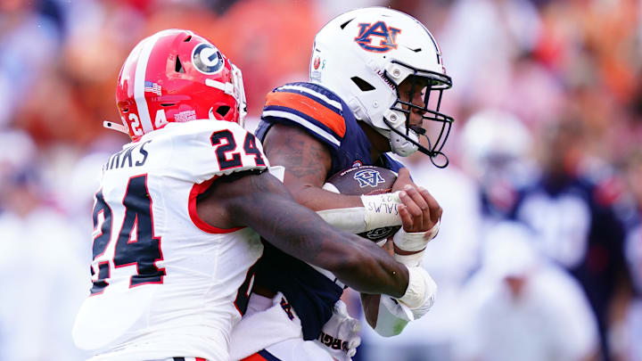 Sep 30, 2023; Auburn, Alabama, USA; Auburn Tigers running back Jarquez Hunter (27) carries the ball against Georgia Bulldogs defensive back Malaki Starks (24) during the first quarter at Jordan-Hare Stadium. Mandatory Credit: John David Mercer-Imagn Images