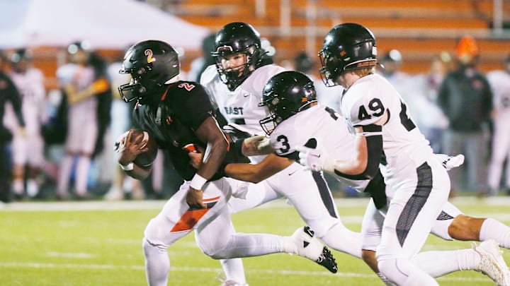 Ames' running back Jamison Poe (2) breaks a tackle from Sioux City East's defensive back/quarterback Kason Clayborne (5), defensive back Dane Milton (3), and linebacker Kuper Fritz (49) and runs for a touchdown during the first quarter at Ames High Football field on Friday, Oct. 13, 2023, in Ames, Iowa.