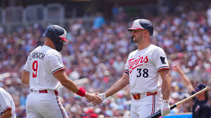 Jul 12, 2025; Minneapolis, Minnesota, USA; Minnesota Twins outfielder Trevor Larnach (9) celebrates his run with designated hitter Matt Wallner (38) against the Pittsburgh Pirates in the second inning at Target Field. Mandatory Credit: Brad Rempel-Imagn Images