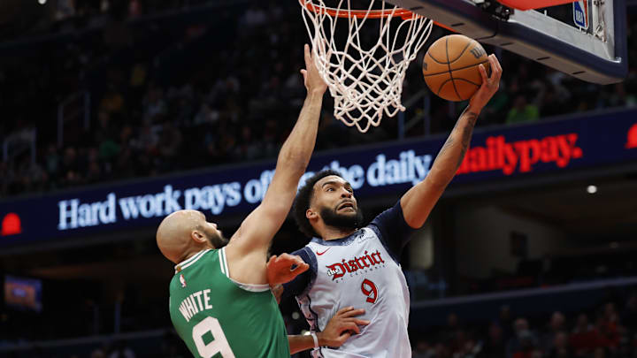 Dec 15, 2024; Washington, District of Columbia, USA; Washington Wizards forward Justin Champagnie (9) shoots the ball as Boston Celtics guard Derrick White (9) defends in the third quarter at Capital One Arena. Mandatory Credit: Geoff Burke-Imagn Images