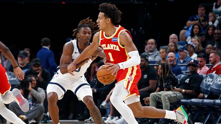 Oct 11, 2025; Memphis, Tennessee, USA;  Atlanta Hawks forward Jalen Johnson (1) dribbles as Memphis Grizzlies guard Javon Small (10) defends during the third quarter at FedExForum. Mandatory Credit: Petre Thomas-Imagn Images