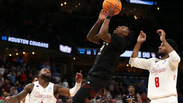 Mar 24, 2024; Memphis, TN, USA; Texas A&M Aggies guard Wade Taylor IV (4) shoots between Houston Cougars guard Jamal Shead (1) and guard Mylik Wilson (8) during over time in the second round of the 2024 NCAA Tournament at FedExForum. Mandatory Credit: Petre Thomas-USA TODAY Sports