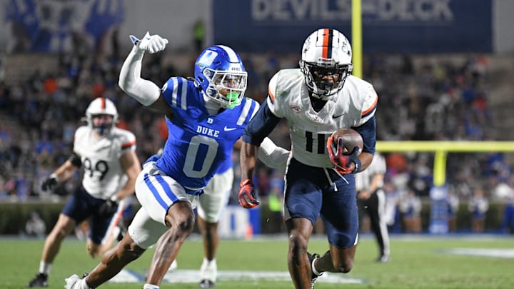Nov 15, 2025; Durham, North Carolina, USA; Duke Blue Devils cornerback Chandler Rivers (0) attempts to swat the ball from Virginia Cavaliers wide receiver Trell Harris (11) during the third quarter at Wallace Wade Stadium. Mandatory Credit: Zachary Taft-Imagn Images Nov 15, 2025; Durham, North Carolina, USA; Duke Blue Devils cornerback Chandler Rivers (0) attempts to swat the ball from Virginia Cavaliers wide receiver Trell Harris (11) during the third quarter at Wallace Wade Stadium. Mandatory Credit: Zachary Taft-Imagn Images