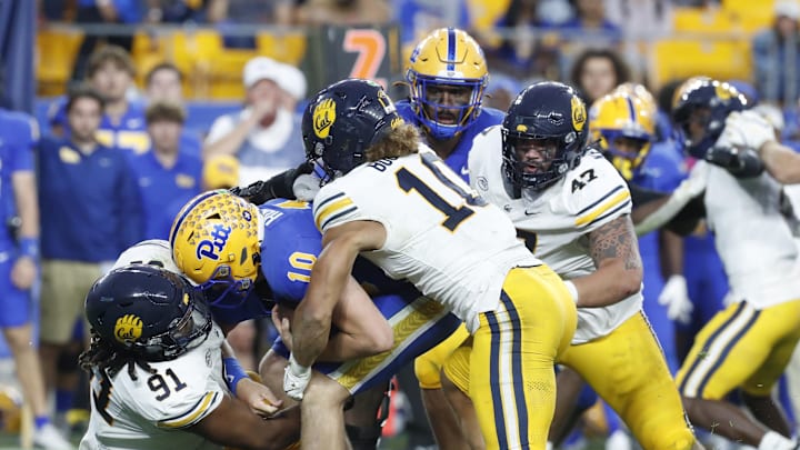 Oct 12, 2024; Pittsburgh, Pennsylvania, USA;  California Golden Bears defensive lineman Ricky Correia (91) and linebacker Teddye Buchanan (10) sack Pittsburgh Panthers quarterback Eli Holstein (10) during the fourth quarter at Acrisure Stadium. Pittsburgh won 17-15. Mandatory Credit: Charles LeClaire-Imagn Images