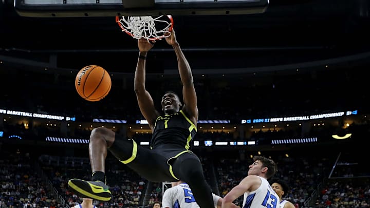 Mar 23, 2024; Pittsburgh, PA, USA; Oregon Ducks center N'Faly Dante (1) dunks the ball against Creighton Bluejays guard Baylor Scheierman (55) in the second round of the 2024 NCAA Tournament at PPG Paints Arena. Mandatory Credit: Charles LeClaire-Imagn Images