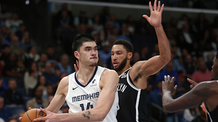 Memphis Grizzlies center Zach Edey (14) handles the ball as Brooklyn Nets guard Ben Simmons (10) defends during the second half at FedExForum. Mandatory Credit: Petre Thomas-Imagn Images
