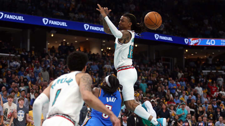 Apr 24, 2025; Memphis, Tennessee, USA; Memphis Grizzlies guard Ja Morant (12) looses control of the ball as he is fouled by Oklahoma City Thunder guard Luguentz Dort (5) during the second quarter during game three for the first round of the 2024 NBA Playoffs at FedExForum. Mandatory Credit: Petre Thomas-Imagn Images