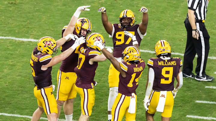 Dec 26, 2025; Phoenix, AZ, USA; Minnesota Gophers defensive back John Nestor (17) celebrates an interception with teammates against the New Mexico Lobos during the first half of the Rate Bowl at Chase Field. Mandatory Credit: Mark J. Rebilas-Imagn Images
