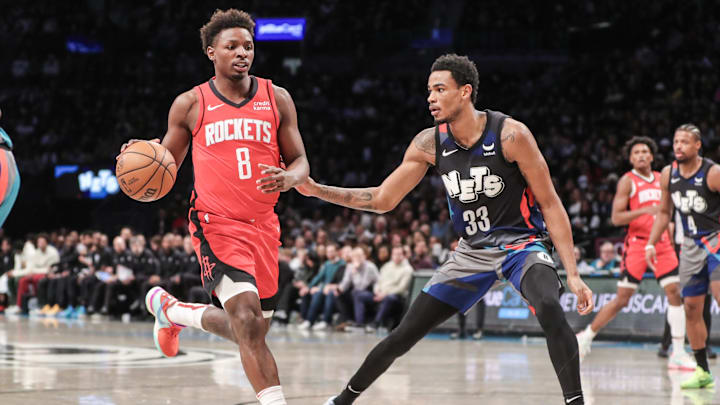 Jan 27, 2024; Brooklyn, New York, USA;  Houston Rockets forward Jae'Sean Tate (8) looks to drive past Brooklyn Nets center Nic Claxton (33) in the fourth quarter at Barclays Center. Mandatory Credit: Wendell Cruz-Imagn Images