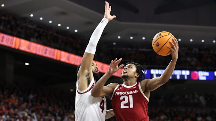 Feb 19, 2025; Auburn, Alabama, USA;  Arkansas Razorbacks guard D.J. Wagner (21) takes a shot as Auburn Tigers forward Johni Broome (44) defends during the first half at Neville Arena. Mandatory Credit: John Reed-Imagn Images