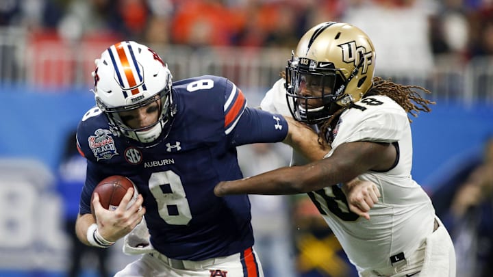 Jan 1, 2018; Atlanta, GA, USA; Auburn Tigers quarterback Jarrett Stidham (8) is sacked by Central Florida Knights linebacker Shaquem Griffin (18) in the second quarter in the 2018 Peach Bowl at Mercedes-Benz Stadium. Mandatory Credit: Brett Davis-USA TODAY Sports