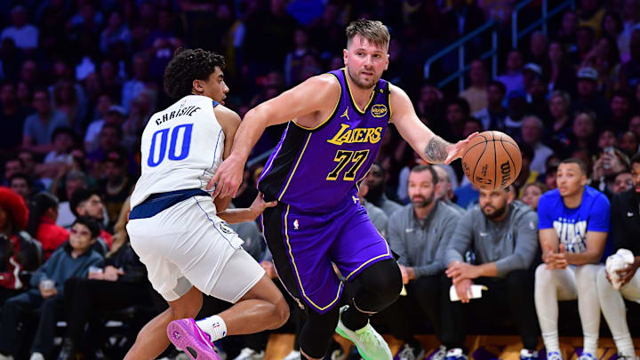 Los Angeles Lakers guard Luka Doncic (77) dribbles the ball past Dallas Mavericks guard Max Christie (00)