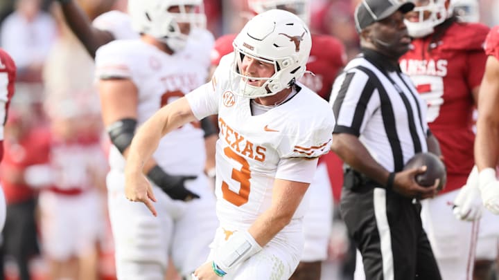 Nov 16, 2024; Fayetteville, Arkansas, USA; Texas Longhorns quarterback Quinn Ewers (3) celebrates after making a final first down to end the game against the Arkansas Razorbacks at Donald W. Reynolds Razorback Stadium. Texas won 20-10. Mandatory Credit: Nelson Chenault-Imagn Images