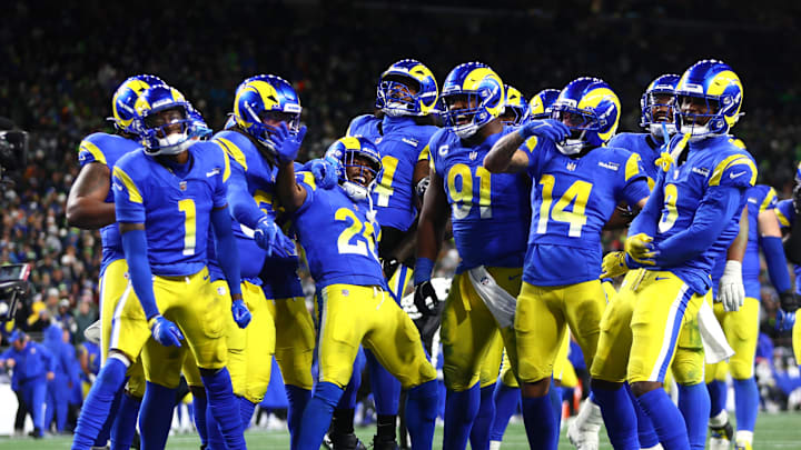 Dec 18, 2025; Seattle, Washington, USA; Los Angeles Rams defensive end Kobie Turner (91) celebrates with teammates after an interception against the Seattle Seahawks in the second half at Lumen Field. Mandatory Credit: Kevin Ng-Imagn Images