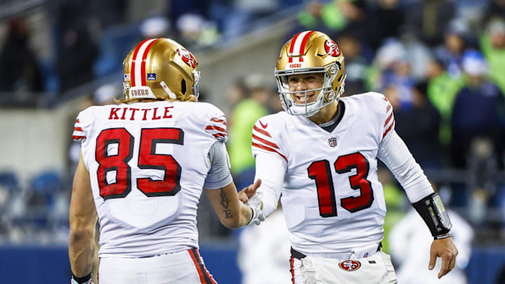 San Francisco 49ers quarterback Brock Purdy (13) celebrates with tight end George Kittle.